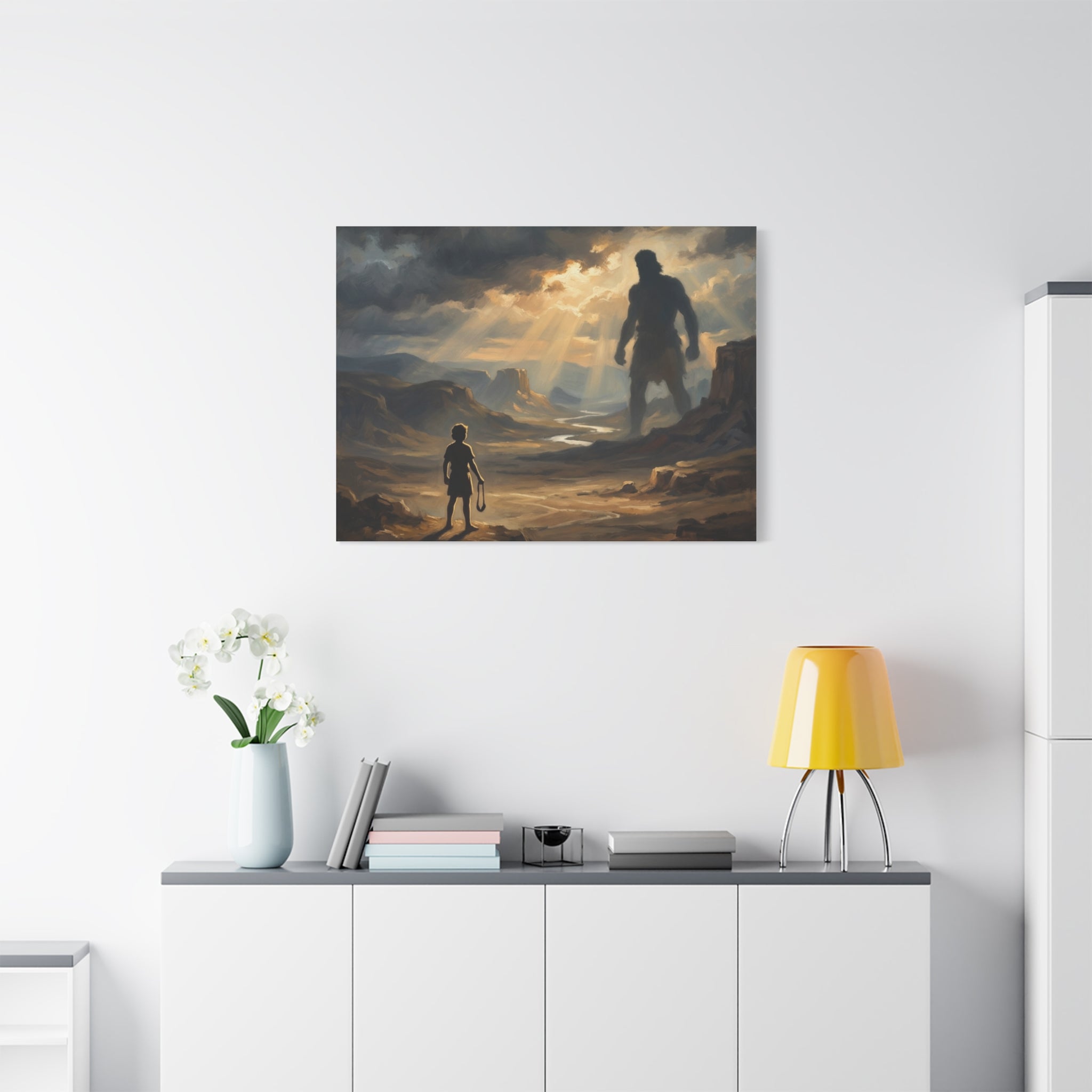An oil painting style print on a stretched canvas depicting a young boy holding a sling, looking out across a sunlit desert valley toward the giant shadow silhouette of Goliath in the distance. - 6