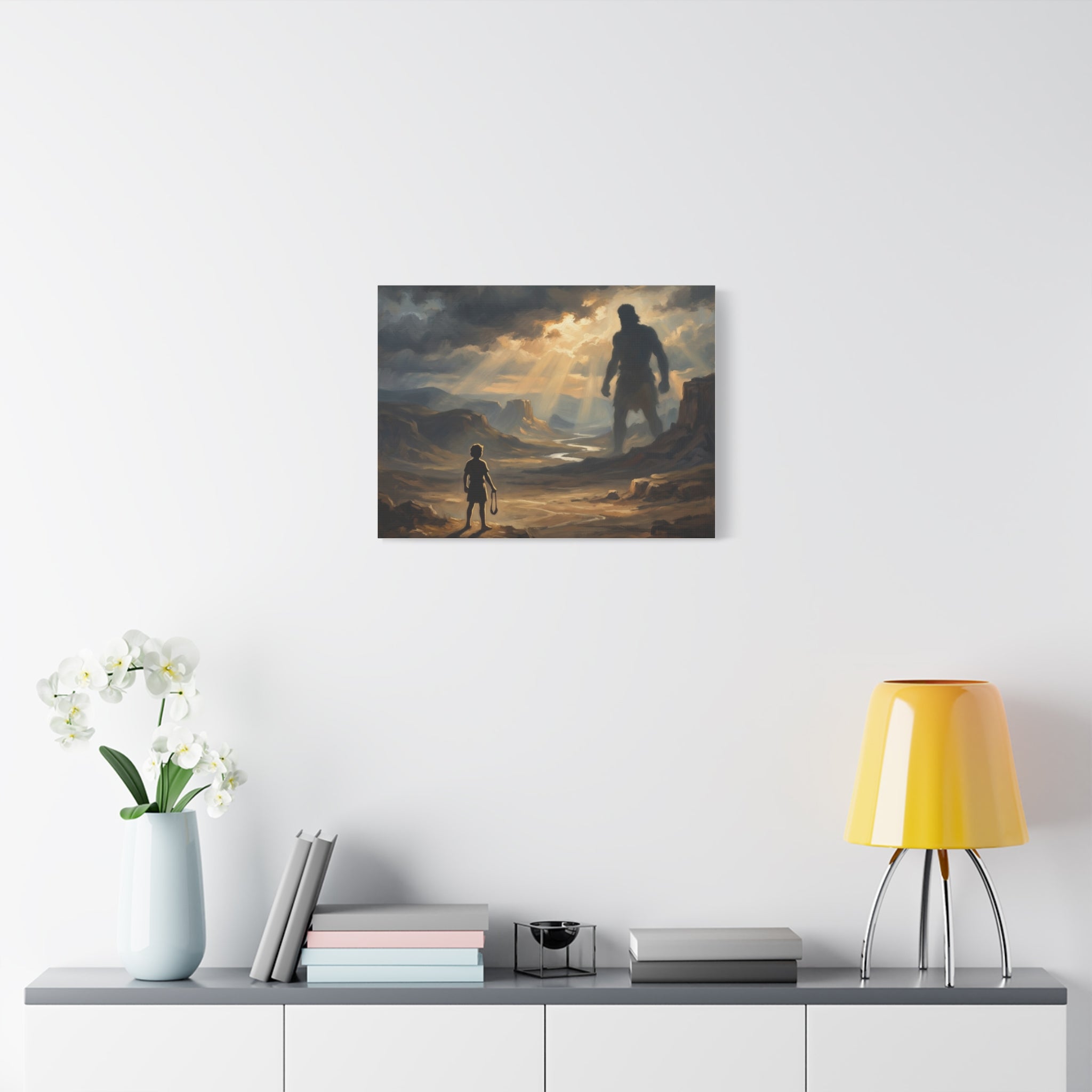 An oil painting style print on a stretched canvas depicting a young boy holding a sling, looking out across a sunlit desert valley toward the giant shadow silhouette of Goliath in the distance. - 5