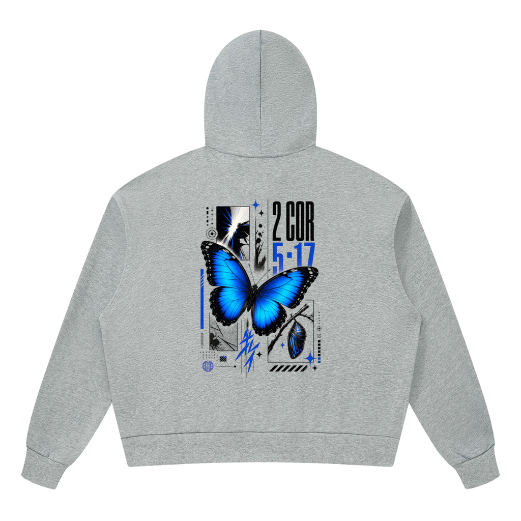 Vibrant electric blue butterfly graphic with bold 2 Corinthians 5 17 scripture typography on the back of a Shomri hoodie.